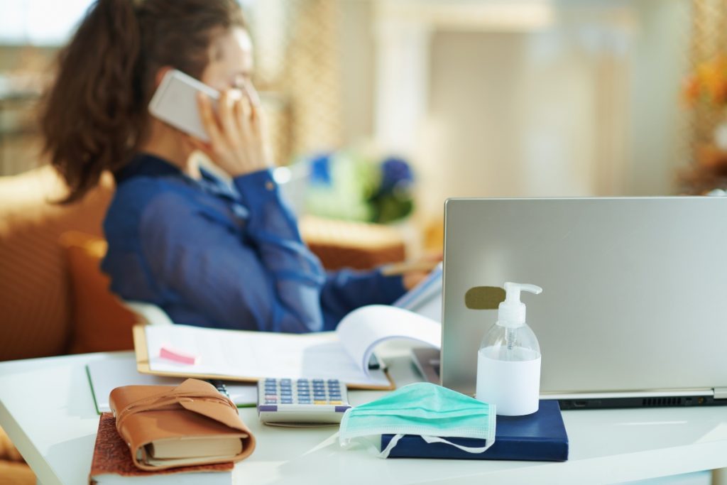 covid mask and hand gel on hr agency work desk